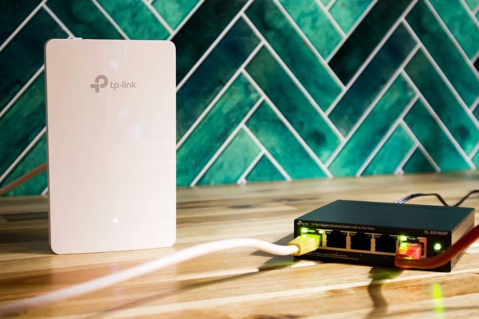 Smart switch device on a modern home wall with blue ambient glow