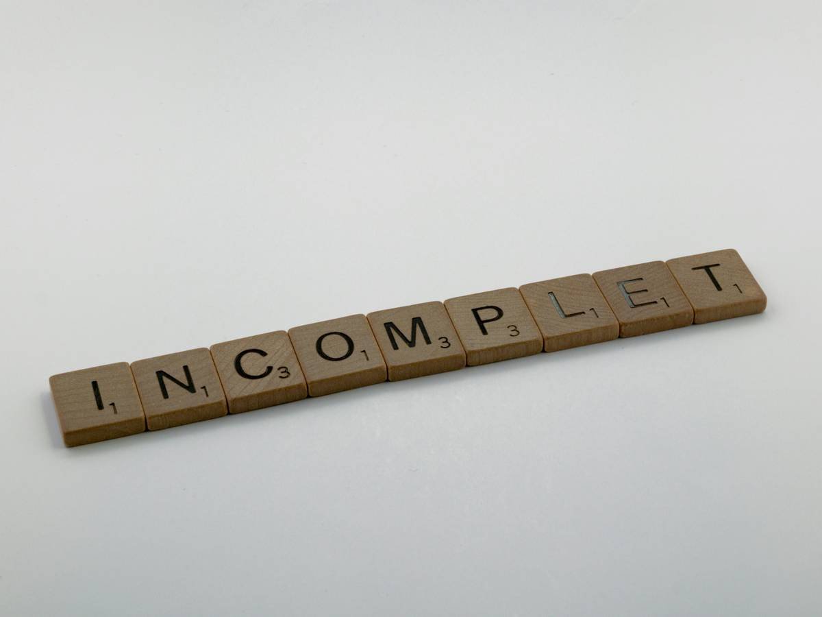 A confused man holding two different types of smart switches next to an electrical panel.