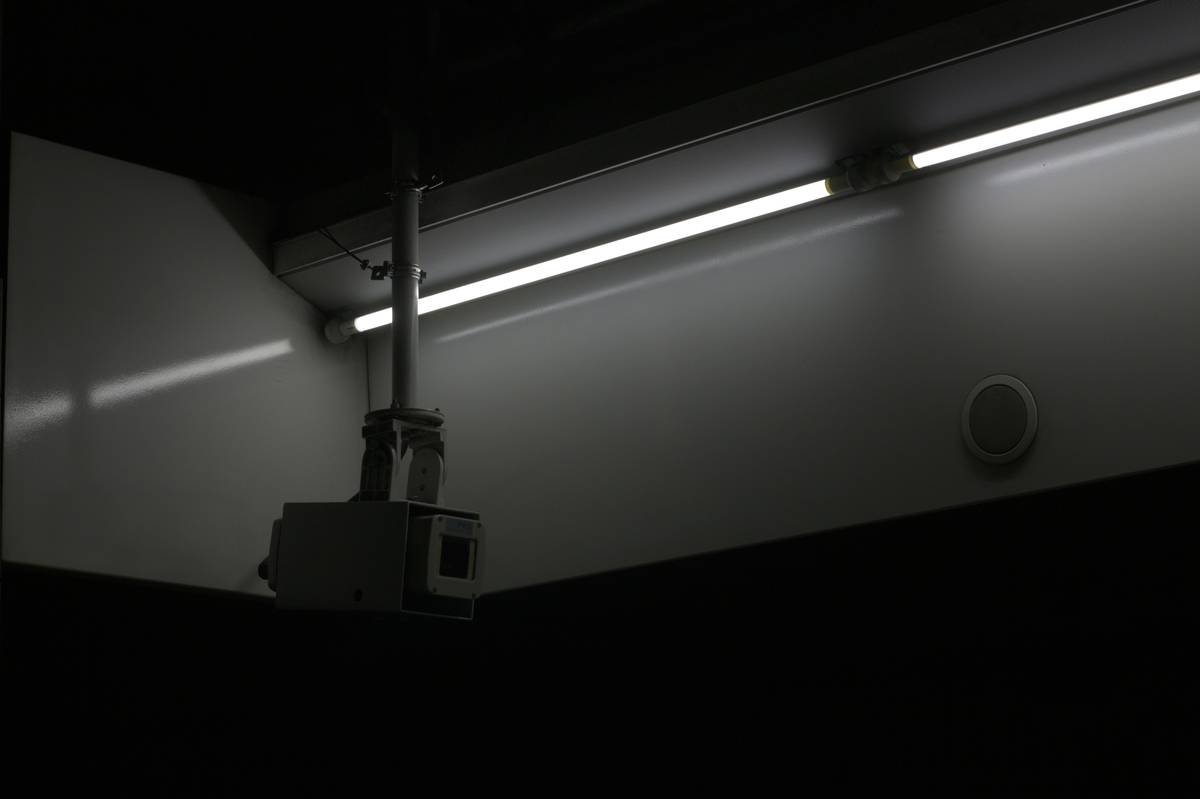 Photo of a smart switch next to a lamp glowing softly in a child's bedroom